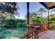 Spacious back yard with lush, tropical landscaping, as seen from the back porch at 510 Pine S Ave, Oldsmar, FL 34677