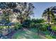 Relaxing back yard with mature trees and landscaping, offering ample privacy at 510 Pine S Ave, Oldsmar, FL 34677
