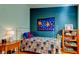 Bedroom with dark blue accent wall, colorful bedspread, and side table with lamp at 510 Pine S Ave, Oldsmar, FL 34677