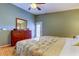 Cozy bedroom featuring a large dresser, ceiling fan, and natural light at 510 Pine S Ave, Oldsmar, FL 34677