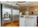 Kitchen with stainless steel refrigerator and white cabinets, offering a clean and modern design at 510 Pine S Ave, Oldsmar, FL 34677