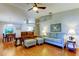 Spacious living room with hardwood floors, vaulted ceilings, ample seating, and views into dining area at 510 Pine S Ave, Oldsmar, FL 34677