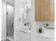 Stylish bathroom with a modern vanity, vessel sink, elegant mirror, and walk-in shower with geometric tiles at 101 W Warren Ave # 2, Tampa, FL 33602