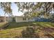 Spacious backyard featuring lush lawn, a chain-link fence, and mature trees offering plenty of shade at 1012 Cronley Pl, Sarasota, FL 34237