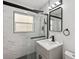 Modern bathroom featuring a glass shower, marble tiling, and updated fixtures at 1012 Cronley Pl, Sarasota, FL 34237