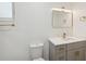 Bathroom features gray vanity, gold fixtures, and quartz countertops at 1012 Cronley Pl, Sarasota, FL 34237
