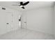 Bedroom showcasing white marble floors, ceiling fan and an ensuite bathroom entrance at 1012 Cronley Pl, Sarasota, FL 34237