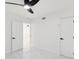 Bedroom featuring white marble floors, a ceiling fan and access to additional rooms at 1012 Cronley Pl, Sarasota, FL 34237