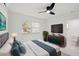 Primary bedroom featuring ensuite bathroom, ceiling fan and modern furniture at 1012 Cronley Pl, Sarasota, FL 34237