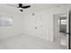 Bright bedroom featuring white marble floors and an ensuite bathroom at 1012 Cronley Pl, Sarasota, FL 34237