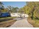Charming single-story home with stone accents, a well-maintained lawn, and a gravel driveway at 1012 Cronley Pl, Sarasota, FL 34237