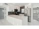 Modern kitchen featuring stainless steel appliances, white cabinets, and stone backsplash at 1012 Cronley Pl, Sarasota, FL 34237