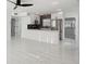 Open concept kitchen and living area features tile floor and stainless fridge at 1012 Cronley Pl, Sarasota, FL 34237