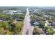 Community aerial view features tree-lined streets, multiple housing options, and proximity to shopping, businesses, and natural landscape at 10131 Lake Oak Cir, Tampa, FL 33624