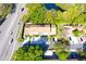 Aerial view of a property and a quiet road and a scenic pond at 10131 Lake Oak Cir, Tampa, FL 33624