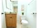 This is a bathroom with a granite vanity, decorative mirror, and a toilet is well-lit and freshly maintained at 10131 Lake Oak Cir, Tampa, FL 33624