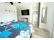 Bright bedroom featuring vinyl flooring, TV, decorative wall art, and plenty of natural light at 10131 Lake Oak Cir, Tampa, FL 33624