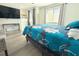 Comfortable bedroom featuring a mounted television, bright windows, wood-look floors, and stylish, modern decor at 10131 Lake Oak Cir, Tampa, FL 33624