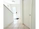 Bright entryway with neutral tiling leads to a secure front door and a glimpse of the upper level at 10131 Lake Oak Cir, Tampa, FL 33624