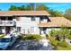 Inviting two-story home boasts a well-kept lawn, ample parking, and cozy front porch at 10131 Lake Oak Cir, Tampa, FL 33624
