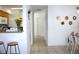 Hallway view with kitchen bar and dining table with chairs, creating an open flow to the home at 10131 Lake Oak Cir, Tampa, FL 33624