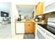 Kitchen sink area with granite countertops, white appliances, and wooden cabinets at 10131 Lake Oak Cir, Tampa, FL 33624
