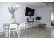 Living room with dining area, vinyl floors, modern light fixture, TV, decor, and sliding glass doors at 10131 Lake Oak Cir, Tampa, FL 33624