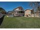 Spacious backyard featuring a pool with screen enclosure and lush lawn at 1028 Rosetree Ln, Tarpon Springs, FL 34689