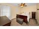 Bedroom with carpeted floors, ceiling fan, dresser, chest, and bed with pillows at 1028 Rosetree Ln, Tarpon Springs, FL 34689