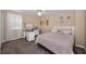 Bedroom featuring a bed, desk, and decorations, creating a cheerful space with carpeted floors at 1028 Rosetree Ln, Tarpon Springs, FL 34689