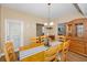 Bright dining area with wooden table set, a hutch, and views of the kitchen at 1028 Rosetree Ln, Tarpon Springs, FL 34689