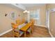 Cozy dining room with a wooden table, chandelier, and a window with sheer curtains at 1028 Rosetree Ln, Tarpon Springs, FL 34689