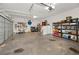 Spacious garage with ample storage and shelving; offering room for two cars or home projects at 1028 Rosetree Ln, Tarpon Springs, FL 34689