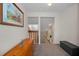 Upstairs hallway featuring a painting, wooden chest, neutral carpet, and bench with storage at 1028 Rosetree Ln, Tarpon Springs, FL 34689