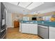 Bright kitchen with stainless steel appliances, and an adjacent living room at 1028 Rosetree Ln, Tarpon Springs, FL 34689