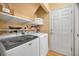 Functional laundry room with modern washer and dryer at 1028 Rosetree Ln, Tarpon Springs, FL 34689