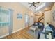Sunlit living room featuring wood-look flooring, a ceiling fan, and cozy furnishings at 1028 Rosetree Ln, Tarpon Springs, FL 34689