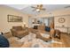 Comfortable living room features plush seating, wood floors, and ceiling fan at 1028 Rosetree Ln, Tarpon Springs, FL 34689