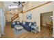 Inviting living room with a staircase, vaulted ceilings, and a comfortable seating arrangement at 1028 Rosetree Ln, Tarpon Springs, FL 34689