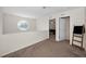 Loft area with unique window and doorway to bedroom with ceiling fan and ensuite bathroom at 1028 Rosetree Ln, Tarpon Springs, FL 34689