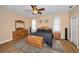 Inviting main bedroom with neutral colors, ceiling fan, and ensuite bathroom access at 1028 Rosetree Ln, Tarpon Springs, FL 34689