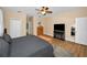Cozy main bedroom with ceiling fan, ensuite bathroom access, and neutral wall color at 1028 Rosetree Ln, Tarpon Springs, FL 34689