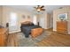 Spacious main bedroom with wood floors, ample closet space, and neutral wall decor at 1028 Rosetree Ln, Tarpon Springs, FL 34689
