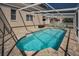 Beautiful private pool with a screened enclosure and brick paver deck at 1028 Rosetree Ln, Tarpon Springs, FL 34689