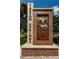 Entrance sign to Tarpon Springs featuring a diving helmet and set in a brick pillar with a stone base at 1028 Rosetree Ln, Tarpon Springs, FL 34689