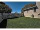 Backyard with well-maintained lawn and privacy fence at 1028 Rosetree Ln, Tarpon Springs, FL 34689