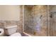 Elegant bathroom featuring a glass-door shower and a modern toilet at 10488 Saint Tropez Pl, Tampa, FL 33615