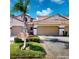 Inviting exterior of a home with a well-maintained lawn, mature palm, and twin mailboxes at 10488 Saint Tropez Pl, Tampa, FL 33615
