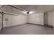 Two car garage with door, ample storage, and epoxy flooring at 10488 Saint Tropez Pl, Tampa, FL 33615