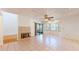 Cozy living space with a tiled floor, fireplace, ceiling fan, and sliding glass doors at 10488 Saint Tropez Pl, Tampa, FL 33615